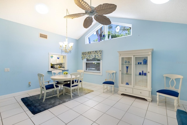 tiled dining space featuring high vaulted ceiling and ceiling fan with notable chandelier