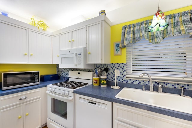 kitchen featuring white appliances, tasteful backsplash, sink, decorative light fixtures, and white cabinets