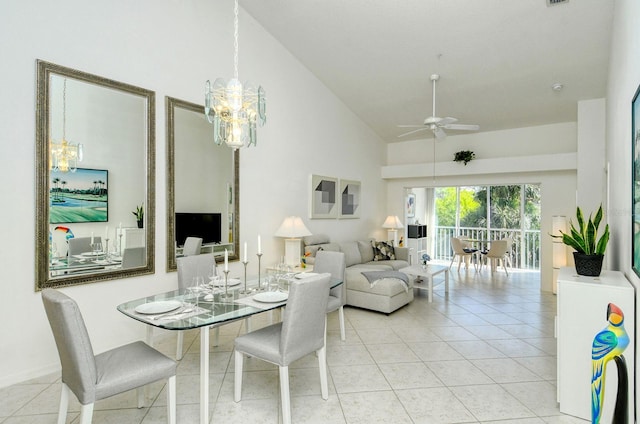 tiled dining room with high vaulted ceiling and ceiling fan with notable chandelier