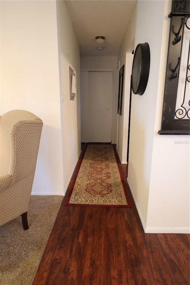 hallway with dark hardwood / wood-style floors