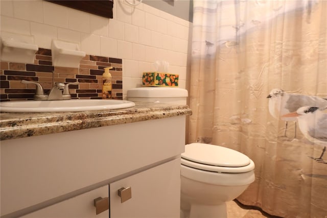 bathroom with decorative backsplash, vanity, and toilet