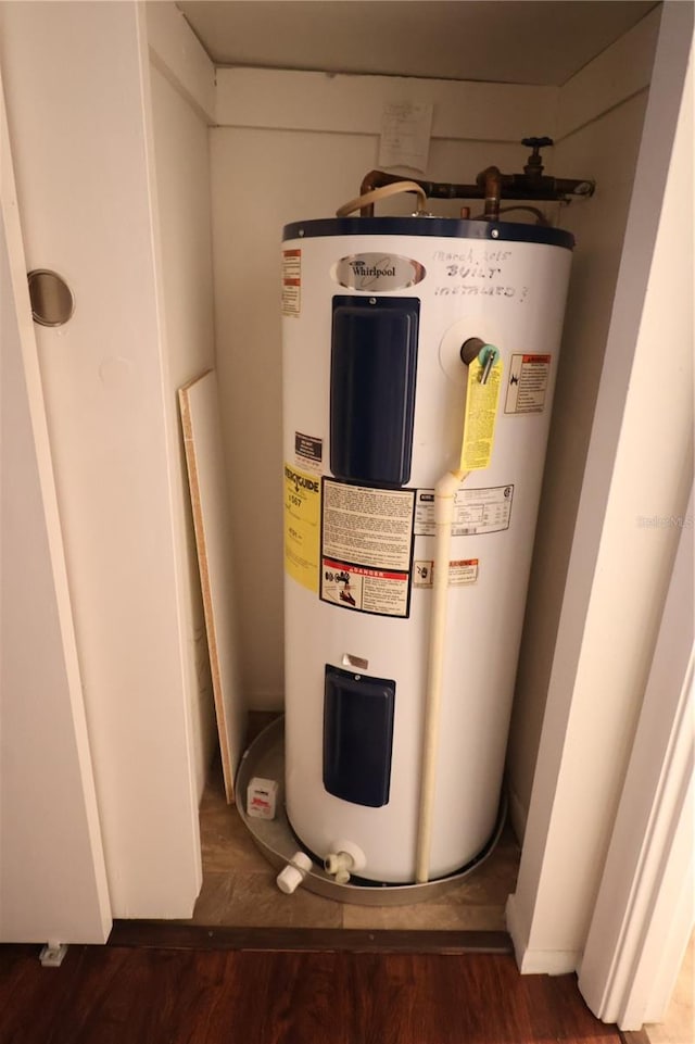 utility room with electric water heater