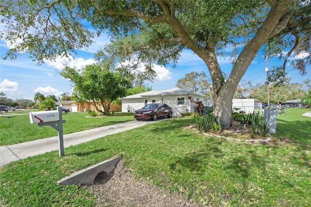 view of front of property with a front lawn and a garage