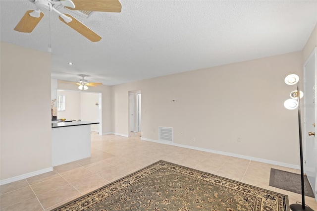 4457 Brooksdale Dr, Sarasota, FL 34232 - unfurnished living room with ceiling fan, light tile patterned floors, a textured ceiling, and baseboards