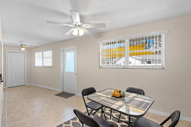 dining room with ceiling fan and light tile patterned floors