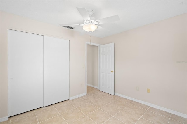 unfurnished bedroom featuring a closet, ceiling fan, and light tile patterned flooring