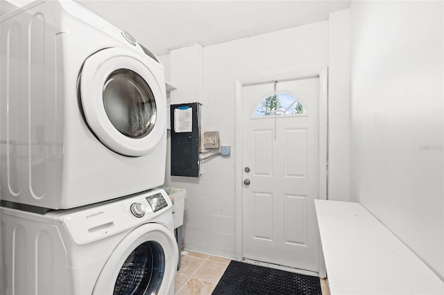 laundry area featuring stacked washing maching and dryer and electric panel