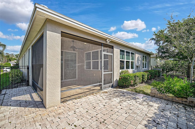 rear view of property featuring a patio and a sunroom