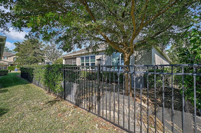 view of gate with a yard