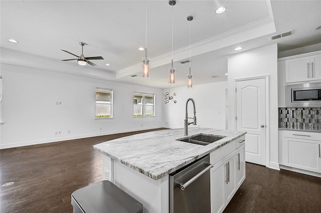 kitchen with stainless steel appliances, white cabinetry, sink, a kitchen island with sink, and pendant lighting