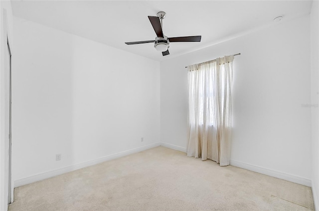 empty room featuring light carpet and ceiling fan