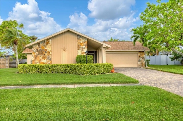 view of front of property with a garage and a front lawn