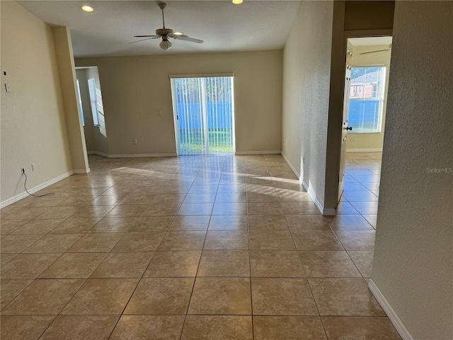 tiled empty room with ceiling fan