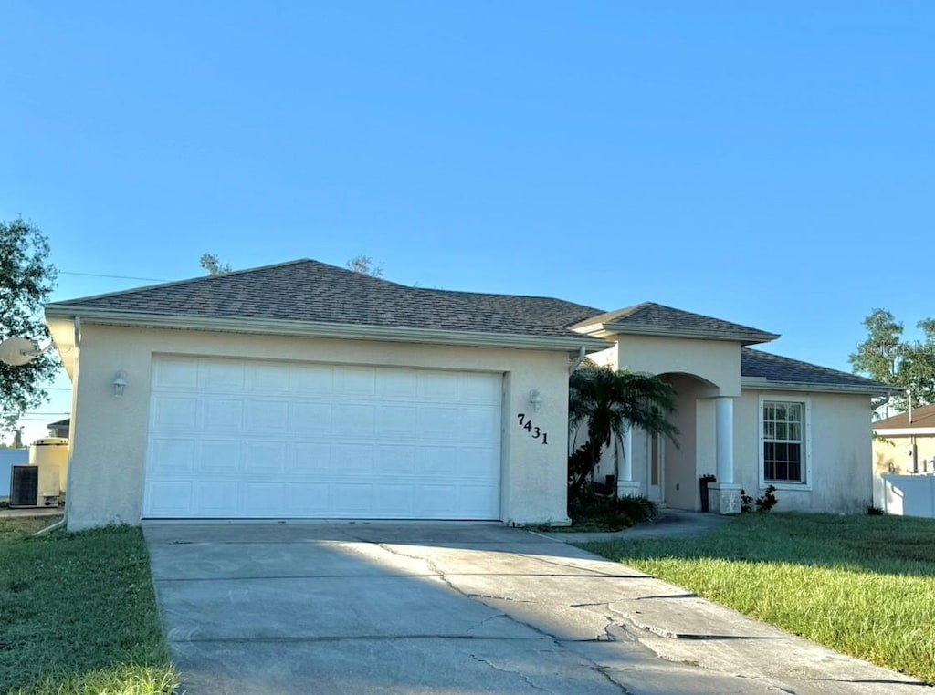 ranch-style home with a garage and a front yard