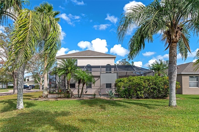 back of property featuring a yard and a lanai