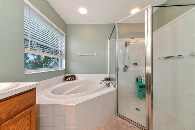 bathroom featuring vanity and shower with separate bathtub