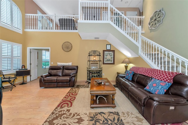 living room featuring a high ceiling and hardwood / wood-style floors