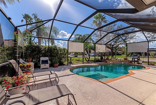 view of swimming pool with glass enclosure and a patio area