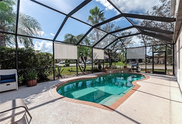 view of swimming pool featuring glass enclosure and a patio area