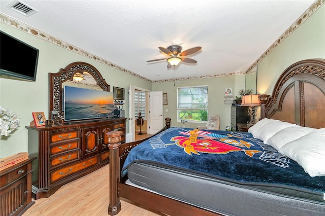 bedroom with light hardwood / wood-style flooring and ceiling fan