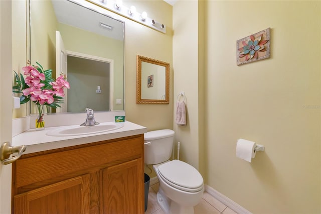 bathroom with tile patterned flooring, vanity, and toilet