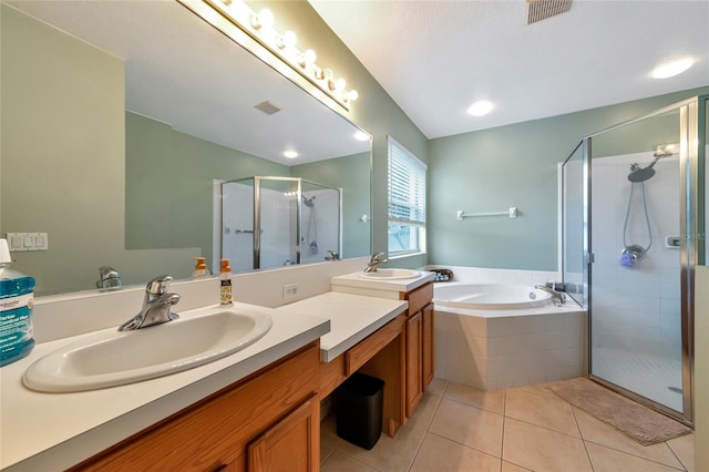 bathroom with tile patterned flooring, shower with separate bathtub, and vanity