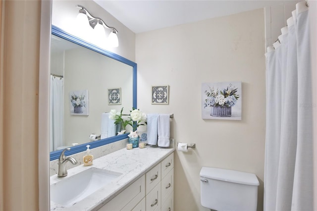 bathroom with toilet and vanity