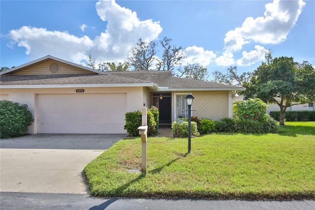 ranch-style home with a garage and a front lawn