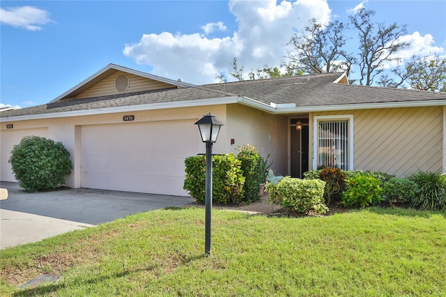 single story home featuring a garage and a front lawn