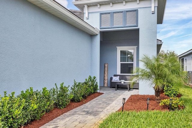 view of exterior entry featuring a patio