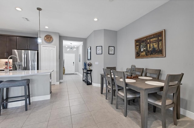 tiled dining space featuring a notable chandelier