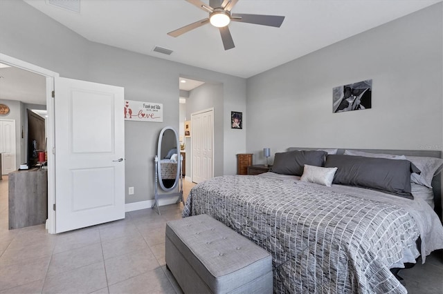 bedroom featuring ceiling fan, a closet, and light tile patterned flooring