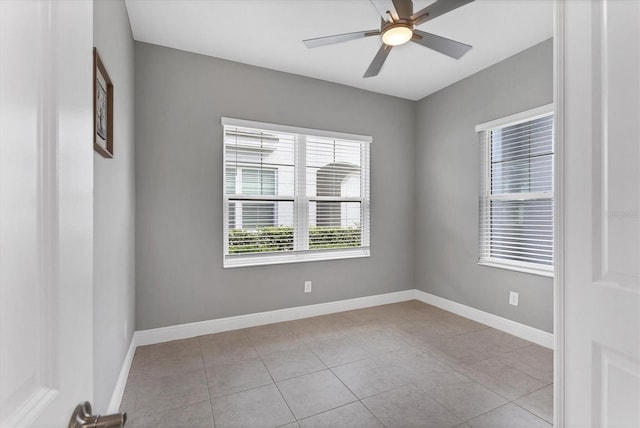 tiled spare room featuring ceiling fan