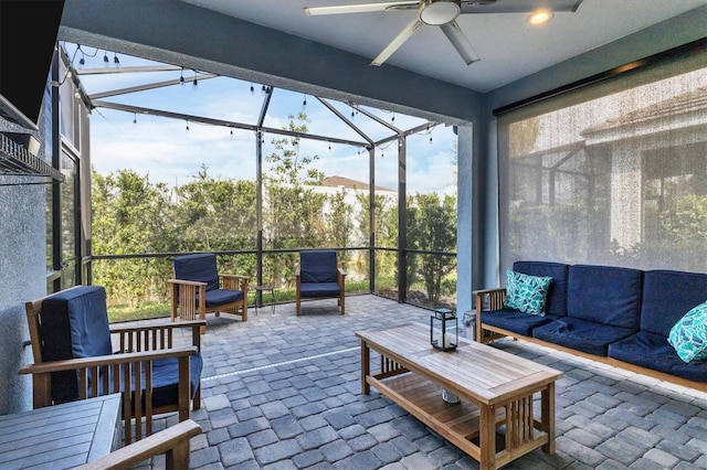 sunroom with a wealth of natural light and ceiling fan