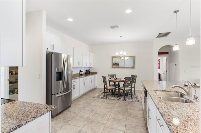 kitchen featuring light stone countertops, sink, white cabinets, and appliances with stainless steel finishes