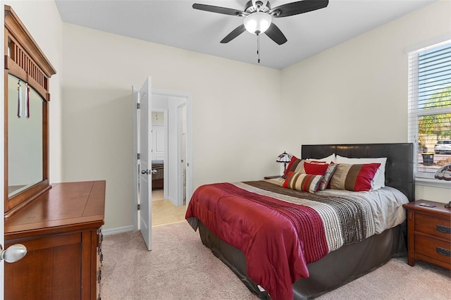 bedroom featuring ceiling fan and light carpet