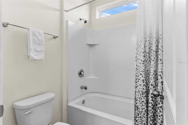 bathroom with shower / tub combo and toilet