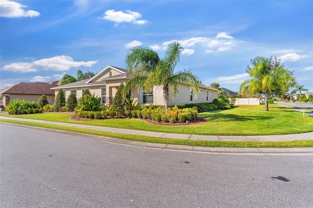 single story home featuring a front yard and stucco siding