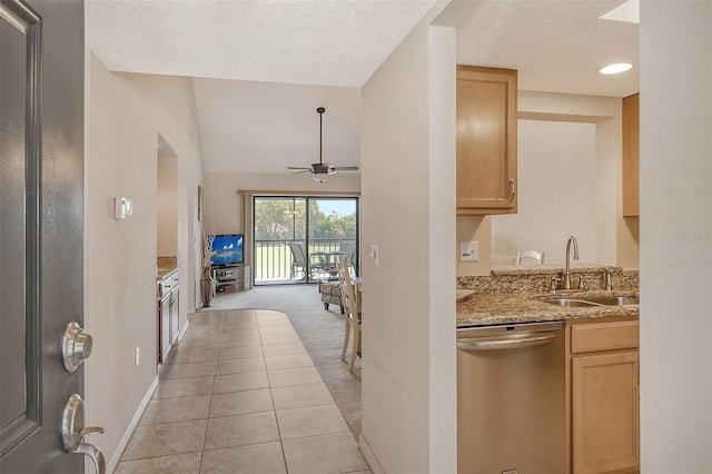 kitchen with dishwasher, light brown cabinets, lofted ceiling, and sink