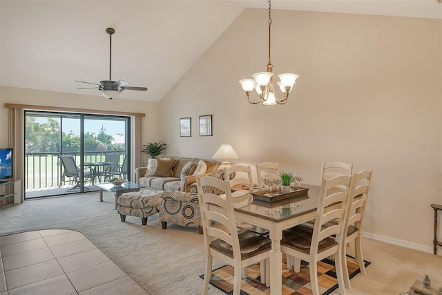 dining room with high vaulted ceiling, ceiling fan with notable chandelier, and light carpet