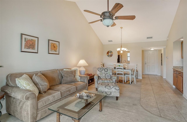 living room featuring high vaulted ceiling, light colored carpet, and ceiling fan with notable chandelier