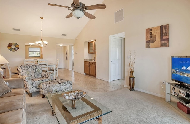 living room with high vaulted ceiling, ceiling fan with notable chandelier, and light tile patterned floors