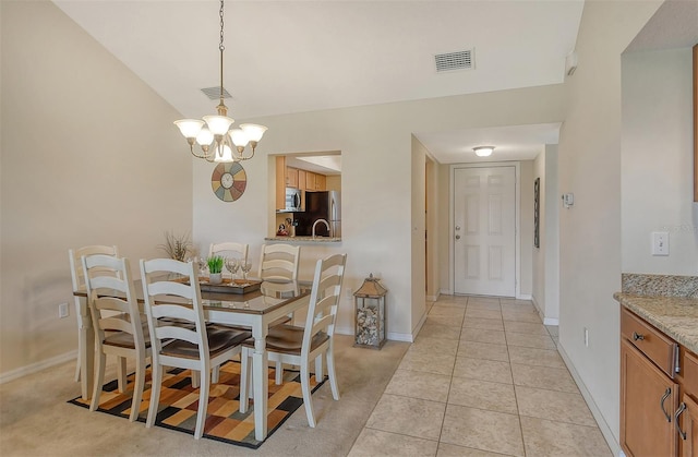 dining area featuring a chandelier and light carpet