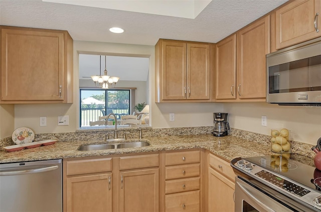 kitchen featuring stainless steel appliances, light brown cabinetry, and sink