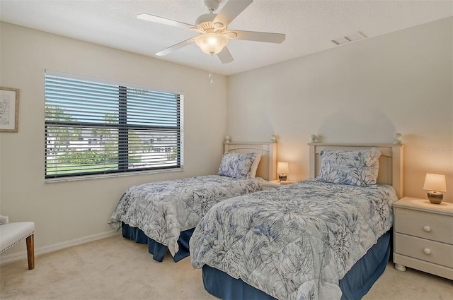 bedroom featuring light carpet and ceiling fan