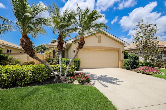 view of front of home with a garage and a front lawn