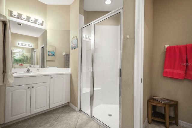 bathroom with vanity, tile patterned floors, and walk in shower