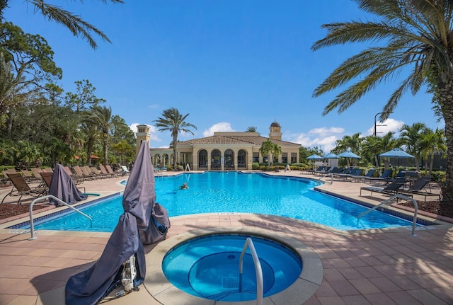 view of swimming pool with a patio and a community hot tub