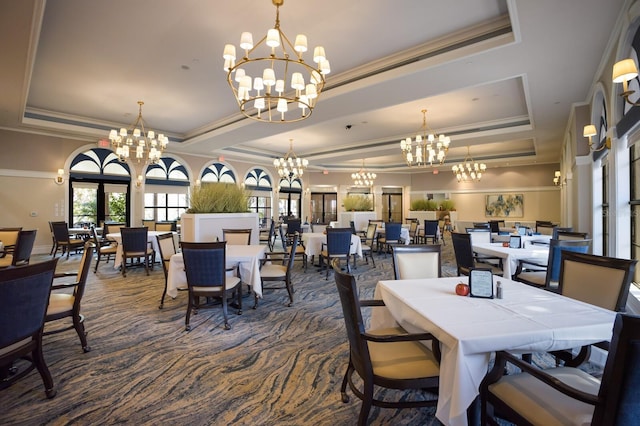 dining room with ornamental molding and a tray ceiling