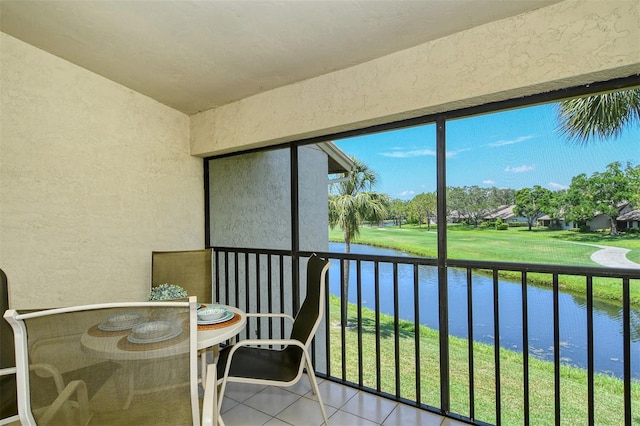 unfurnished sunroom featuring a water view